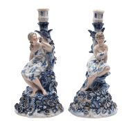 A pair of German porcelain figural candlesticks,
