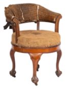 An Edwardian oak circular revolving office armchair; with a padded back and hessian seat,