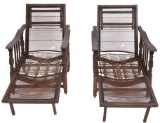 A pair of oak metamorphic reclining armchairs, circa 1900; the adjustable rectangular backrests,