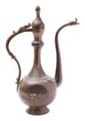 A large Middle Eastern copper alloy ewer of flattened bulbous form with slender neck and long