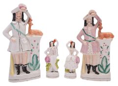 Two pairs of Staffordshire pottery figures,