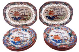 An English pottery part service decorated with an oriental design of a fenced garden in underglaze