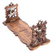 A 'Black Forest' carved limewood book slide, probably Swiss,