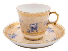 A Sevres Napoleon III porcelain cup and saucer painted in blue monochrome with flower sprays on a