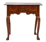 An 18th-century oak lowboy; with an overhanging rectangular top,
