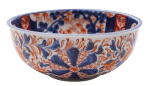 A Japanese Fukagawa Imari bowl painted with panels of bamboo and prunus beyond lattice fences,