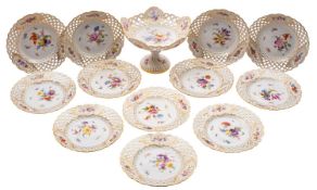 A Meissen part dessert service with shaped and gilded pierced basket weave rims,