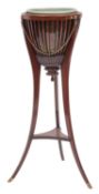 An Edwardian mahogany brazier type jardiniere stand; the slatted urn with brass and ceramic liners,