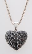 A heart-shaped pendant, probably set with sapphires, stamped '750', length of pendant ca. 1.