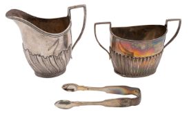 A George V silver cream jug, Charles Stuart Harris, London 1902, of part swirl fluted form,