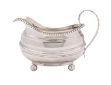 A George IV silver cream jug, maker George Knight, London 1820, of barge shape, egg and dart rim,
