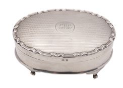 A George V silver dressing table casket, P J Finch Ltd, Birmingham 1933, of oval form,