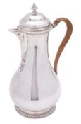 A George II/ III silver hot water pot, maker Thomas Heming, London 1760, of baluster form,
