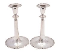 A pair of George V silver candlesticks, Wakely & Wheeler (James Wakely & Frank Clarke Wheeler),