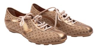 Salvatore Ferragamo. A pair of gold leather and canvas trainers, with dust bag.