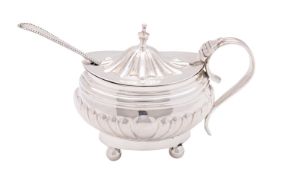 A Victorian silver mustard pot, maker Robert Sebbings, London 1900, of oval part reeded form,
