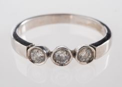 An 18ct gold and diamond three stone ring, set with three brilliant cut diamonds, approximately 0.