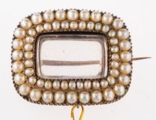 A Victorian seed pearl brooch, cushion shaped with vacant glass locket to centre,