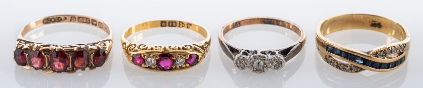 Four gem set rings, to include: a ruby and diamond ring, stamped 18,