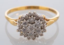 An 18ct gold diamond cluster ring, set with brilliant cut and eight cut diamonds,