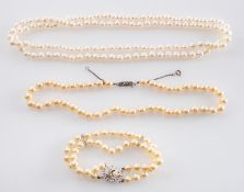 Three items of cultured pearl jewellery including, two single-row necklaces,