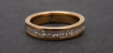 A step and princess-cut diamond half eternity ring, total estimated diamond weight ca. 0.