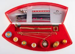 Milus a Swiss watch set comprising a watch contained within a red box with various additions to