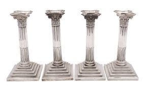 A pair of Edward VII silver Corinthian column candlesticks, Goldsmiths & Silversmiths Co Ltd,