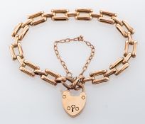 A 9ct gate link bracelet, composed of polished gate links, with a padlock clasp, stamped 375,
