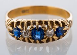 A sapphire and diamond ring, set with three circular cut sapphires and two old cut diamonds,
