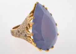 A gem set dress ring, the pear shaped purple stone within a claw mount,
