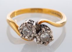 An 18ct gold and diamond two stone ring, set with two brilliant cut diamonds, approximately 0.