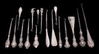 A collection of sixteen silver handled button hooks with plain, engine turned and embossed handles,