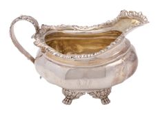 A George IV silver cream jug, makers mark rubbed out, London 1820, of lobbed barge shape,