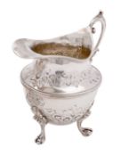A Victorian silver cream jug, maker George Nathan & Ridley Hayes, Birmingham 1894, of helmet shape,