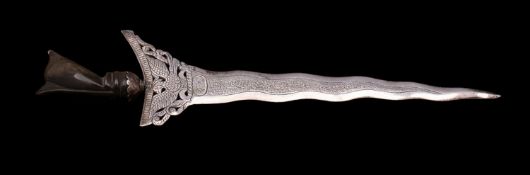 An Indonesian silver paper knife, in the form of a kris with buffolo horn handle,