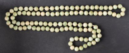 A jade bead necklace, diameter of beads ca. 9.5mms, total length ca. 106cm.