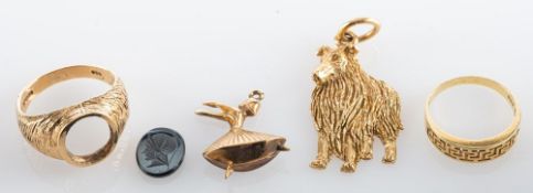 A 9ct gold dog pendant, 9ct gold ring with intaglio seal (loose), a gold ballerina pendant,