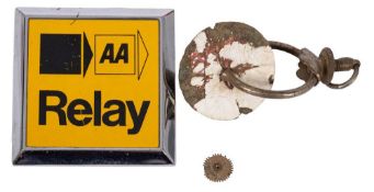 An AA badge and a bicycle dress holder.