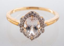 A 9ct gold ring, with an oval, mixed-cut, light brown topaz and CZ surround, ring size N,