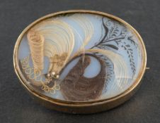 A 19th century hairwork memorial locket brooch, with glazed compartment to verso, total length ca.