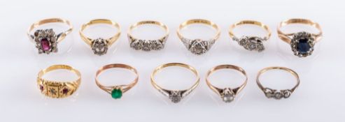 A collection of eleven gem set rings, including three illusion set three stone diamond rings,