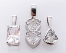 A Platinum Danburite Pendant, the rectangular stone claw set, and Two Platinum White Topaz Pendants,