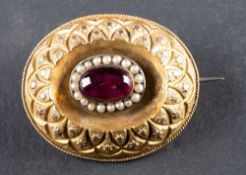A foil backed, probably red paste and seed pearl locket brooch, with glazed compartment to verso,