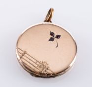 A circular shaped locket, set with three