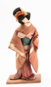 A Post-War linen doll of a geisha, reputedly made from medal ribbons,