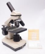 A Bresser Biolux AL 20x-1280x microscope with PC Ocular attachment and software, boxed.
