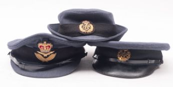 Two RAF peaked caps and a Wren's hat.