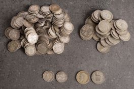 A quantity of silver George V sixpences and threepences.