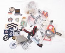 A collection of British, Commonwealth and Foreign cloth insignia, including shoulder flashes etc.